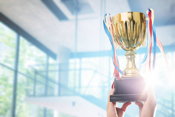 istock Businessman holding award trophy for show their victory. 841764672