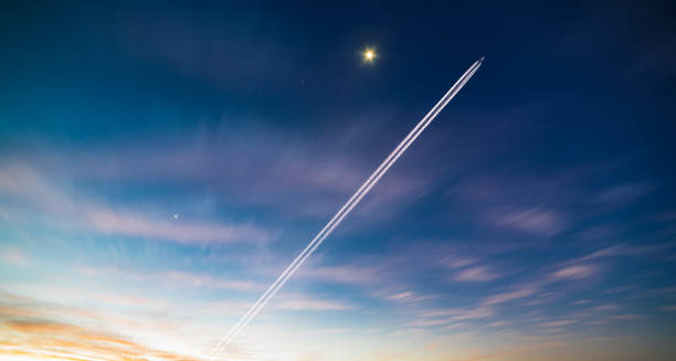 istock Airplane contrail against clear blue sky 841764804