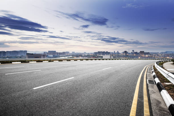 istock empty road with cityscape of modern city in blue sky 841766032