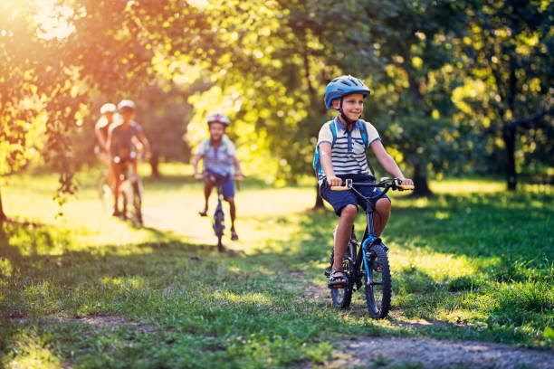 istock Family riding bicycles in park 841773510
