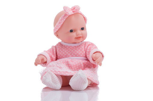 Cute little plastic baby doll isolated on white background