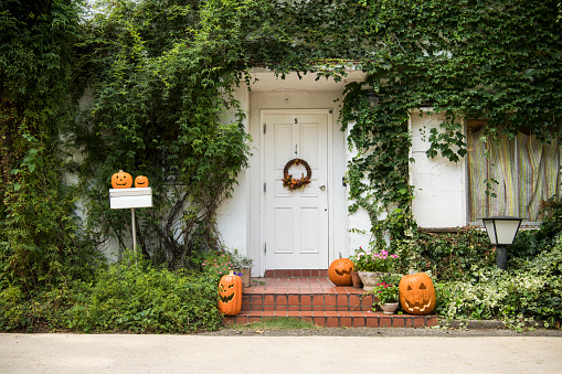 A picture of a house decorated on the day of Halloween.