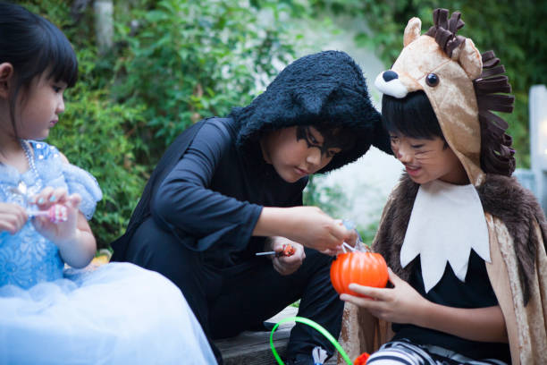 istock Children sitting outside and eating candy. 841795732