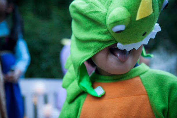 istock A boy wearing a dinosaur to mischief outside. 841795774