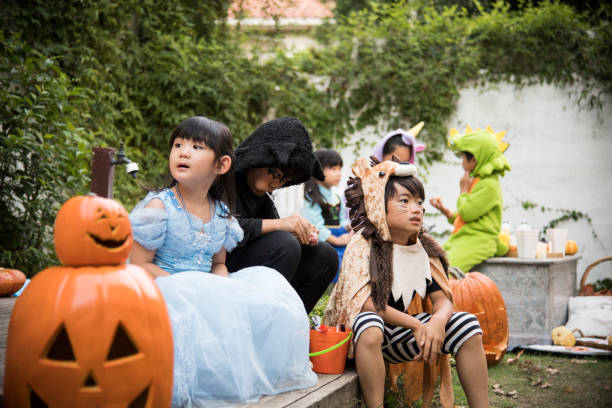 niños vestidos con trajes y jugando afuera. - costume halloween lion baby fotografías e imágenes de stock