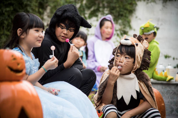 Children licking candy in the yard.