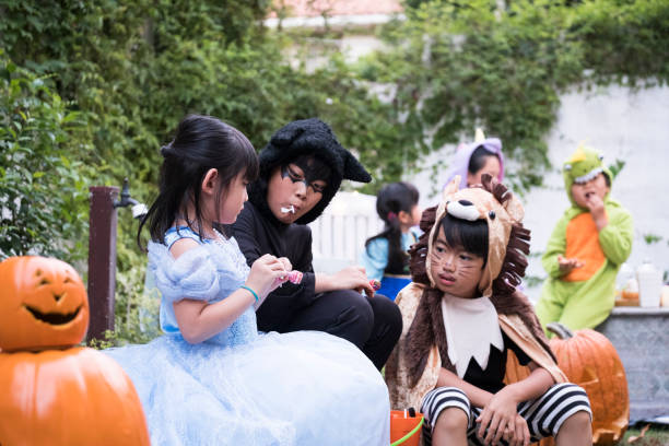 istock Children sitting on the patio and licking candy. 841796148