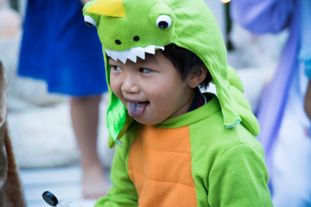 istock A boy wearing a dinosaur to mischief outside. 841798304