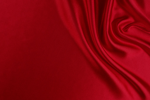 Diagonal textural background of three types of natural linen fabric, rolled up. Selective focus. Closeup view