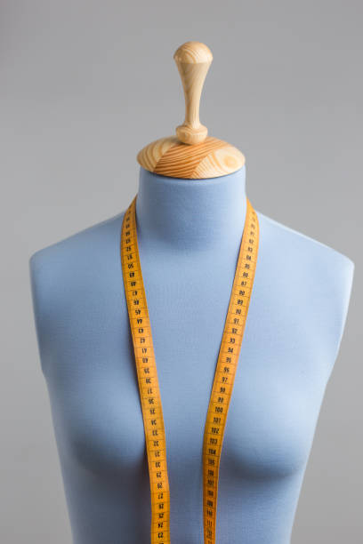 istock Blue tailor dummy with measuring tape alongside the wall. 841807106