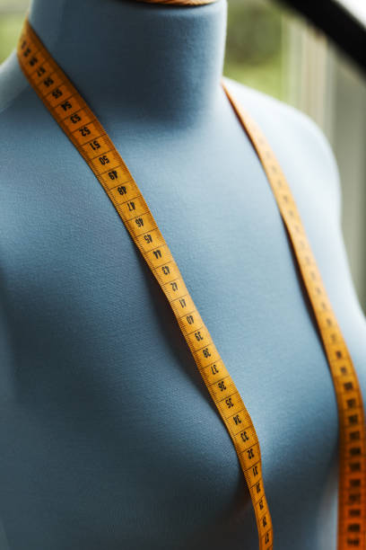 istock Blue tailor dummy with measuring tape close up photo. 841807234