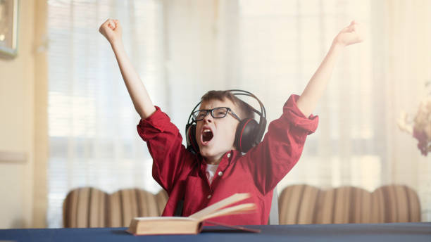 istock Cute boy listening and singing a song with emotions 841811208