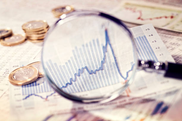 Magnifying glass shows the development of the market stock photo