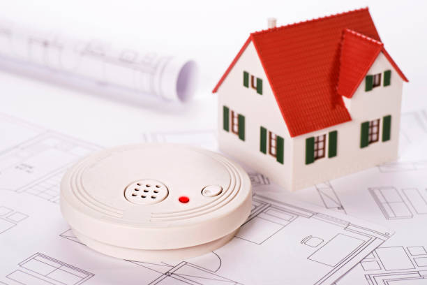 Safety through smoke detectors Smoke detector with house and construction plans animal den photos stock pictures, royalty-free photos & images