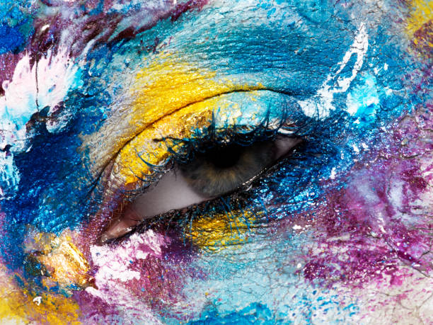istock Beauty, cosmetics and makeup. Magic eyes look with bright creative make-up. Macro shot of beautiful woman's face with perfect art make up. Closeup of female eye. Body art 841815388