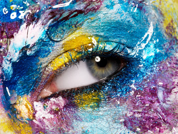 istock Beauty, cosmetics and makeup. Magic eyes look with bright creative make-up. Macro shot of beautiful woman's face with perfect art make up. Closeup of female eye. Body art 841815408