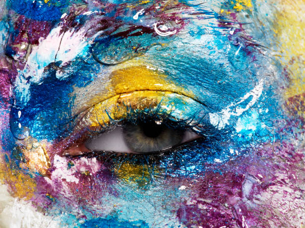 istock Beauty, cosmetics and makeup. Magic eyes look with bright creative make-up. Macro shot of beautiful woman's face with perfect art make up. Closeup of female eye. Body art 841815410