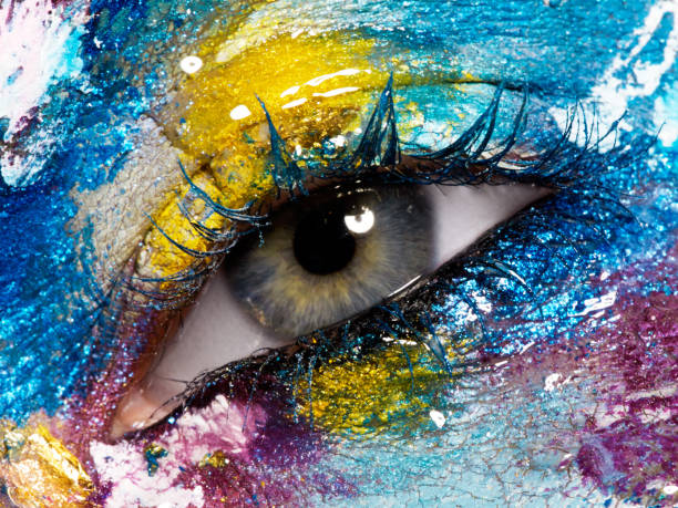 istock Beauty, cosmetics and makeup. Magic eyes look with bright creative make-up. Macro shot of beautiful woman's face with perfect art make up. Closeup of female eye. Body art 841815418