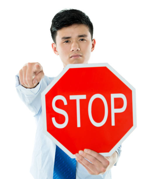 istock Young businessman holding STOP sign 841826008