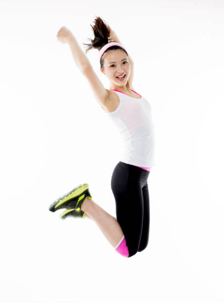 istock Cheerful asian woman jumping against white background 841829494