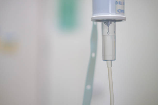 istock Close up saline solution drip for patient and infusion bottle with IV solution in patient room in hospital. 841829688