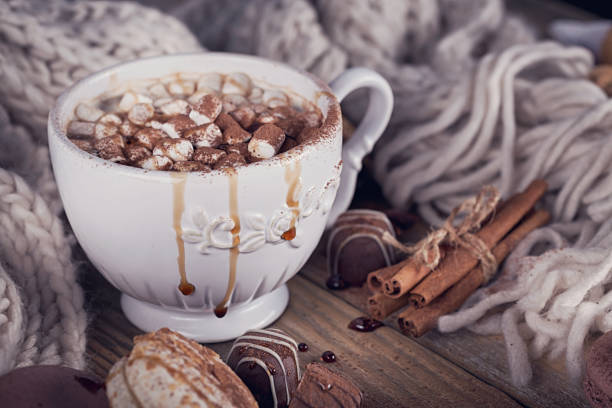 istock Christmas or New Year composition with hot chocolate or cocoa and marshmallows, decorated with sweets, spices and knitted scarf. 841831940