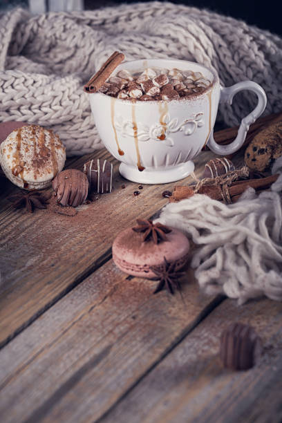 istock Christmas or New Year composition with hot chocolate or cocoa and marshmallows, decorated with sweets, spices and knitted scarf. 841831960