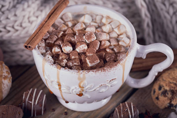 istock Christmas or New Year composition with hot chocolate or cocoa and marshmallows, decorated with sweets, spices and knitted scarf. 841832066