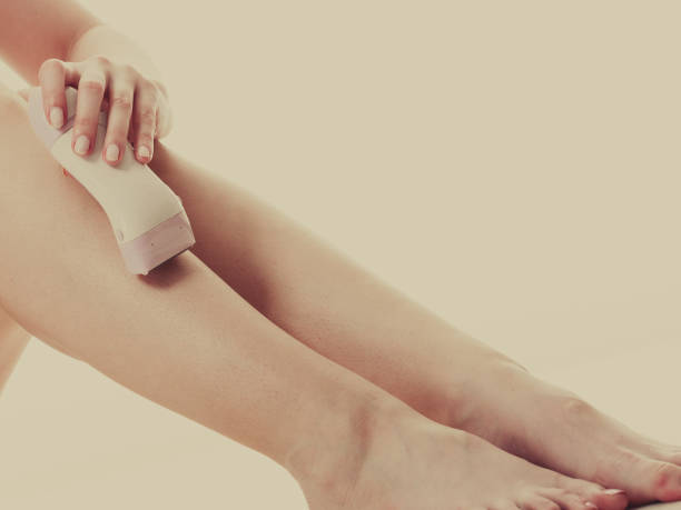 istock Woman shaving her legs with electric razor 841832642