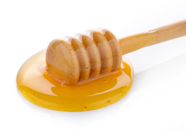 istock Wooden honey dipper with honey 841833420