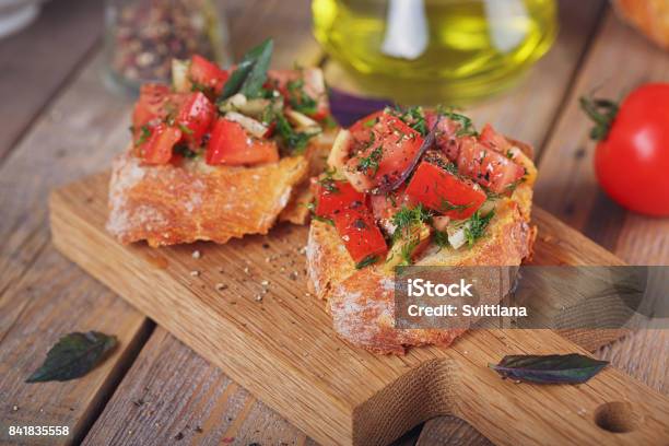 Bruschetta With Chopped Tomatoes Basil And Herbs On Grilled Crusty Bread Stock Photo - Download Image Now