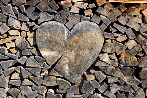 A heart created from bits and pieces of discarded wood hangs from a black door in Bergen, Norway.