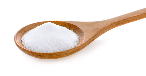 istock Salt in wooden spoon on white background 841846656