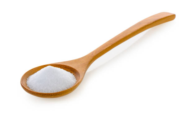 istock Salt in wooden spoon on white background 841847006