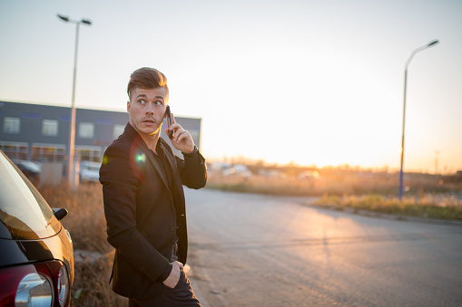 Attractive young businessman talking on the phone
