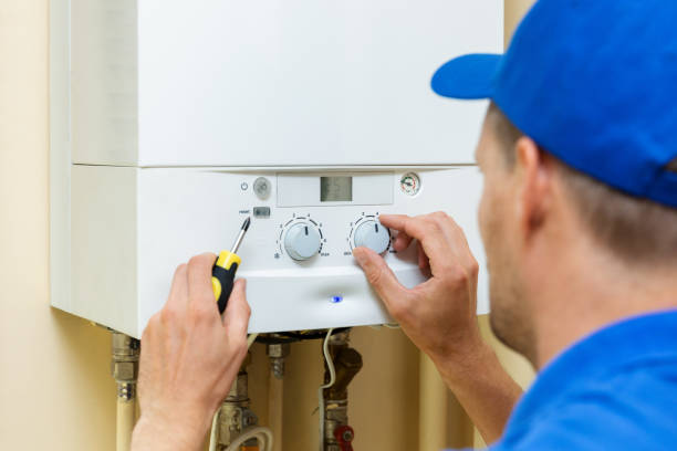 worker set up central gas heating boiler at home worker set up central gas heating boiler at home boiler stock pictures, royalty-free photos & images