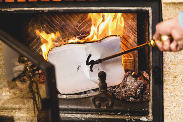 istock Sheets of paper burning in fire of fireplace. 841848968