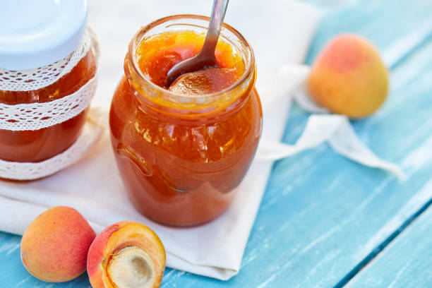 istock Apricot jam in glass jars on table 841851678