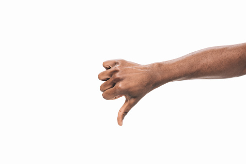 cropped shot of human hand showing  thumb down isolated on white