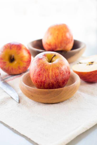 istock whole and sliced apples with leaves on white background 841855278