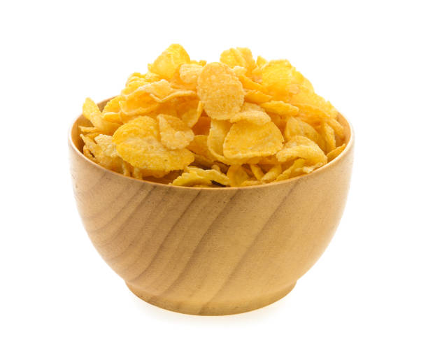istock corn flakes in wood bowl isolated on white background 841859624