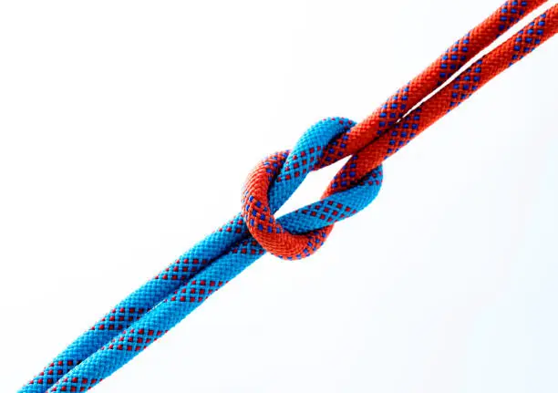 Photo of Rope with reef knot isolated on white background