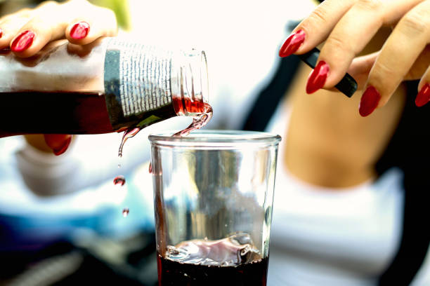 Young woman poured the juice into a glass