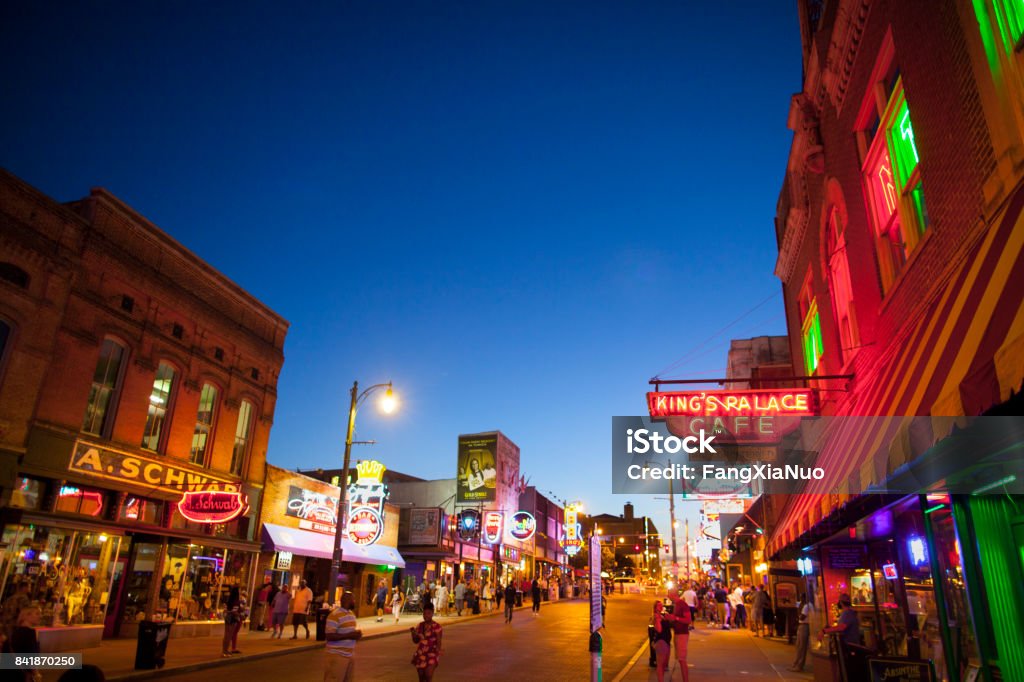 View of Beale Street, Memphis, TN Memphis, TN, USA - June 25, 2017: View of a crowd of tourists enjoying the music clubs and retail establishments that line the famous music district of Beale Street in downtown Memphis, TN at dusk.  Beale Street is on the U.S. National Register of Historic Places. Memphis - Tennessee Stock Photo