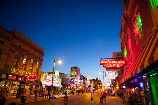 View of Beale Street, Memphis, TN Memphis, TN, USA - June 25, 2017: View of a crowd of tourists enjoying the music clubs and retail establishments that line the famous music district of Beale Street in downtown Memphis, TN at dusk.  Beale Street is on the U.S. National Register of Historic Places. memphis tennessee stock pictures, royalty-free photos & images