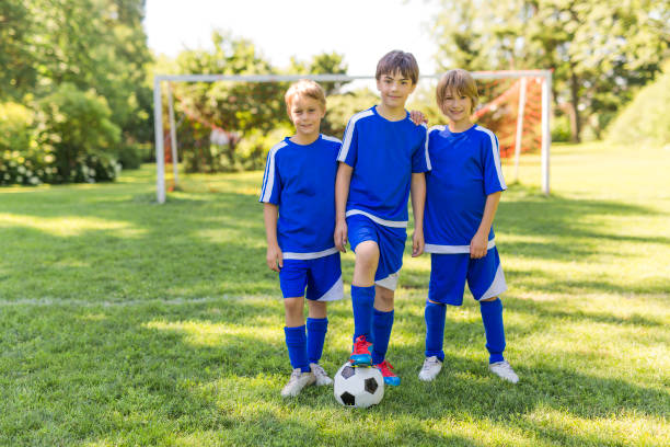 istock three, Young boy with soccer ball on a sport uniform 841877616