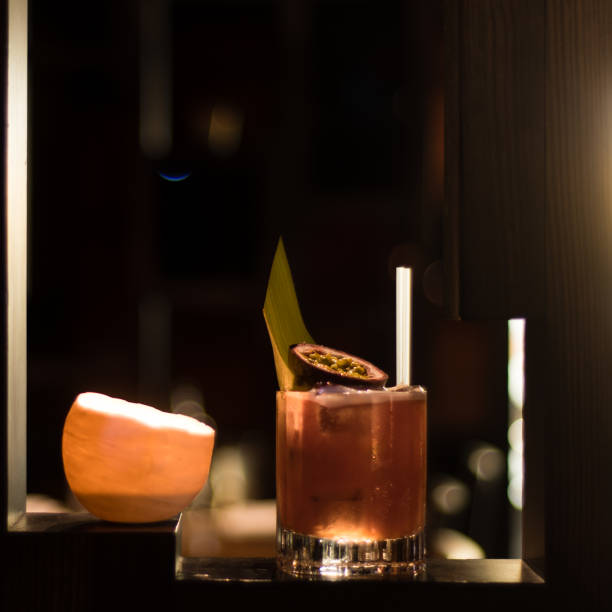 istock Fruit cocktail lit by candle garnished with fig and leaf 841877678