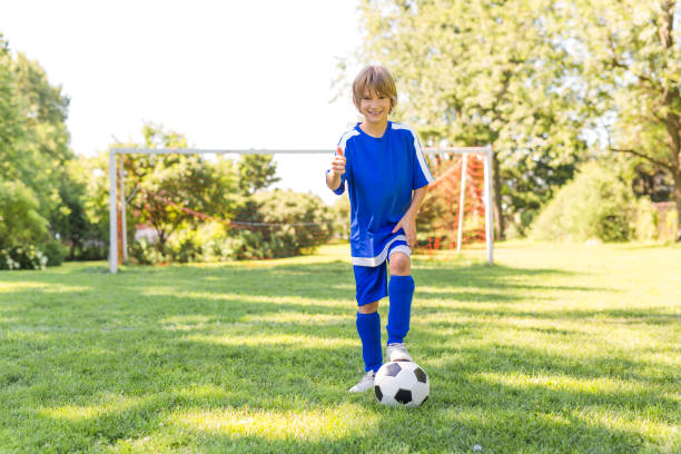 istock Young boy with soccer ball on a sport uniform 841877722