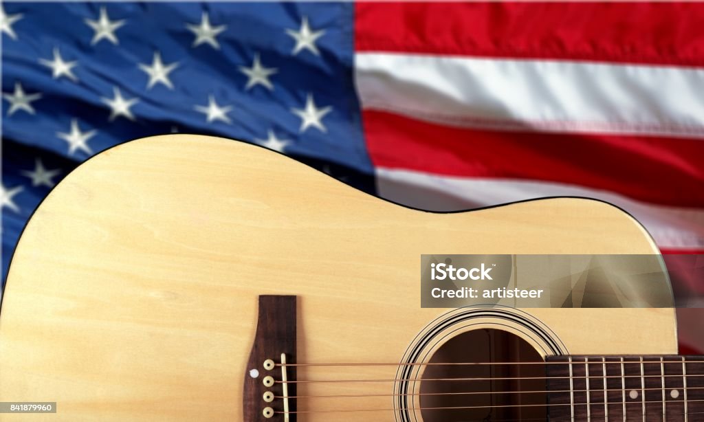 Guitar. Acoustic guitar close up on american flag background American Flag Stock Photo
