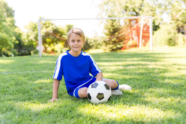 istock Young boy with soccer ball on a sport uniform 841880034